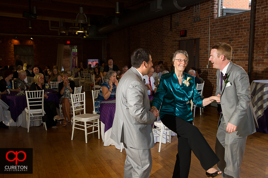 The groom dances with his grandmother.