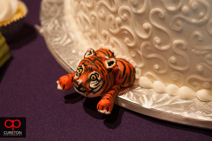 A CLemson tiger coming out of the wedding cake.