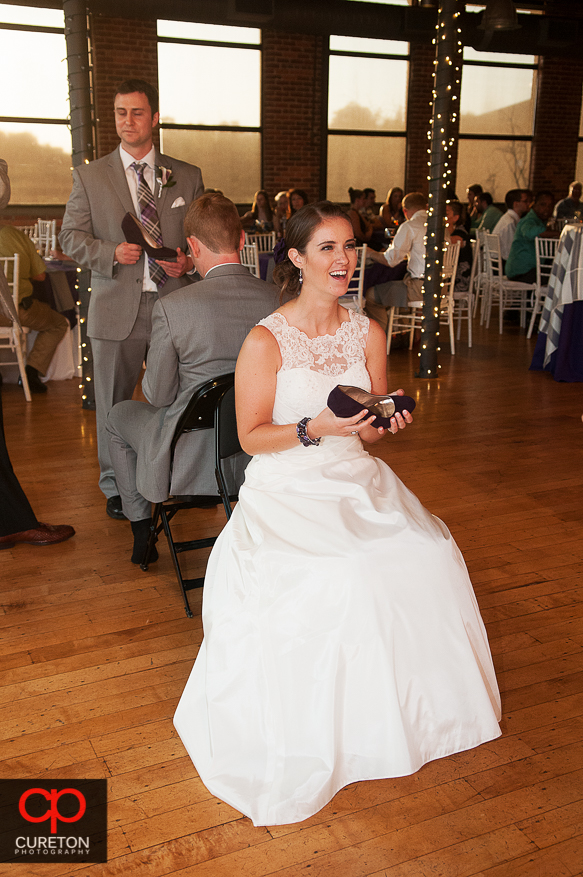 The bride and groom playing a game at the wedding reception.