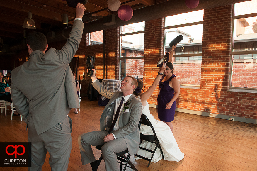 The bride and groom playing a game at the wedding reception.