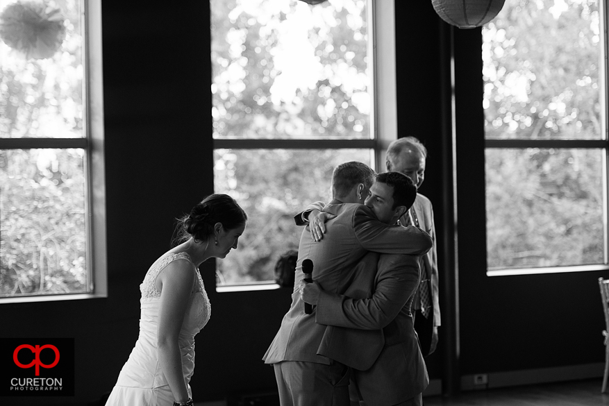 Groom hugging his best man.