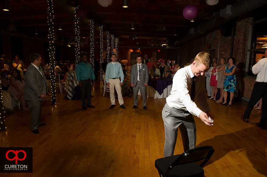 The groom tossing the garter.