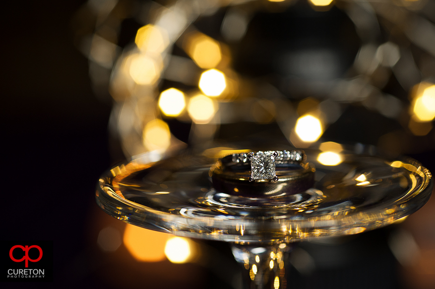 Wedding ring close up with light sin the background.