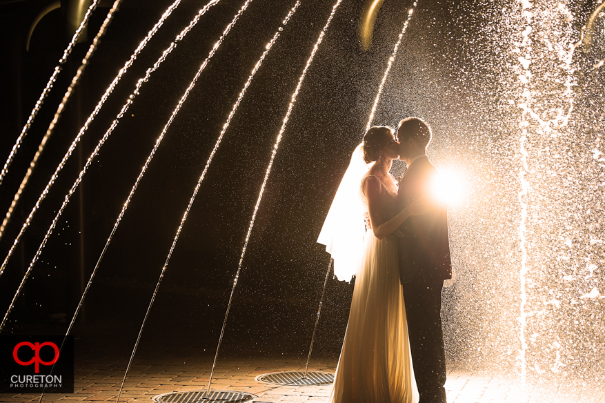 Bride and Groom playing in the fountain their Commerce Club wedding in Greenville,SC.