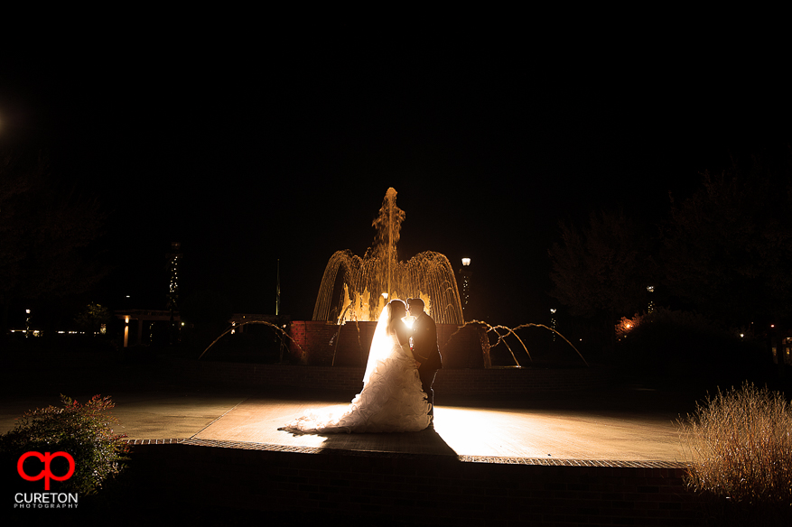 Couple kissing at the fountains in downtown Greer,SC.