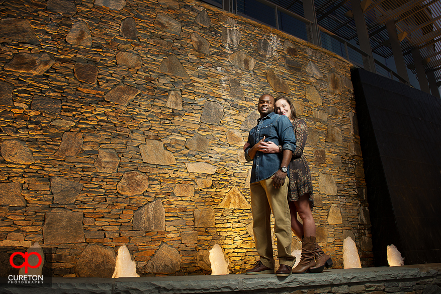 Couple standing next to the water behind the Peace Center during their downtown Greenville SC engagement session..
