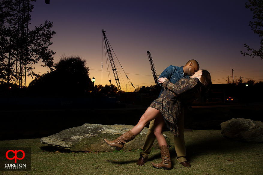 Couple dips at sunset during their downtown Greenville SC engagement session.