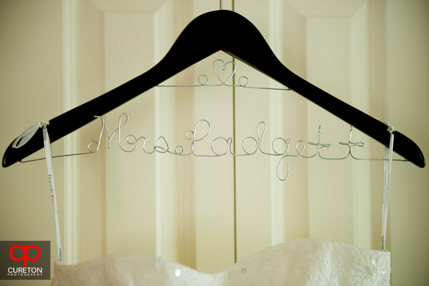The brides name on her dress hanger.