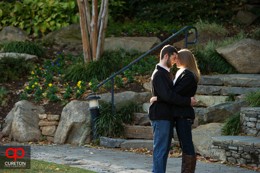 A couple standing at the top of Falls Park in Greenville,SC during their engagement session.