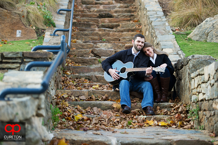 A man plays guitar for his fiancee in Falls Park in downtown Greenville,SC.