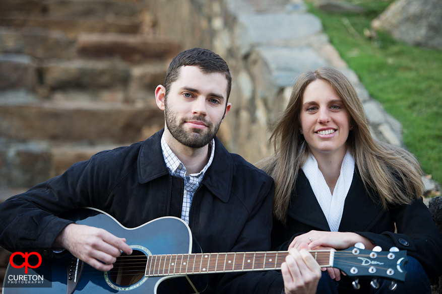 A couple with a guitar in Falls Park.