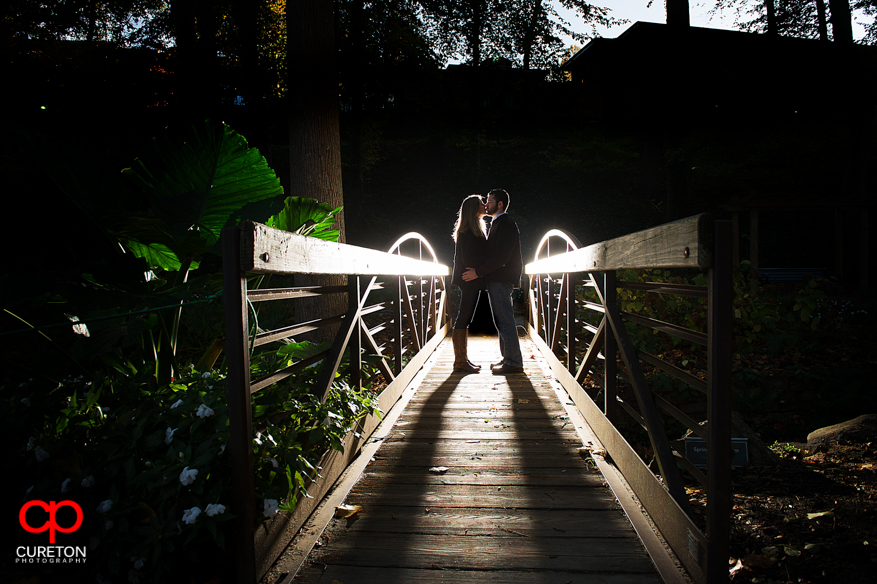 Couple kissing on a bridge in downtown Greenville,SC.