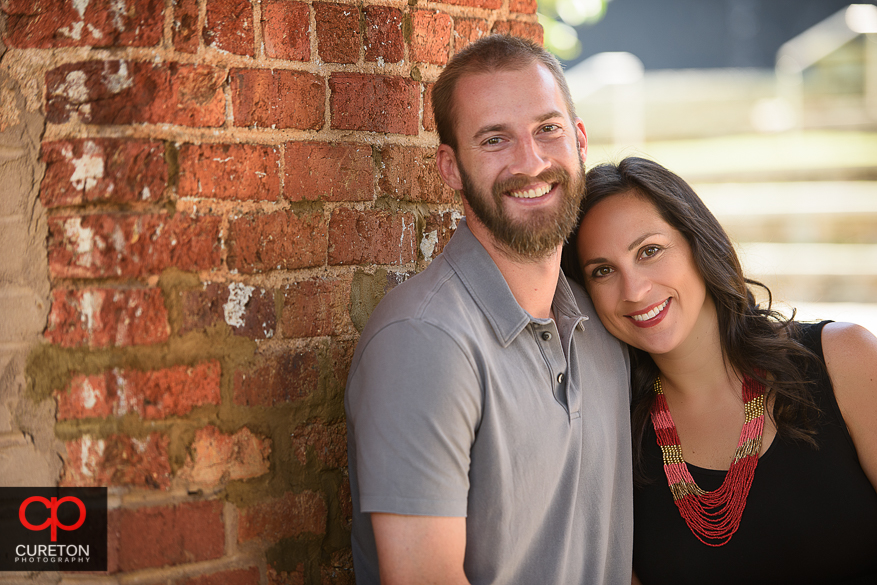 Bride and Groom smiling at the camera at the Wyche Pavilion in downtown Greenville, SC.