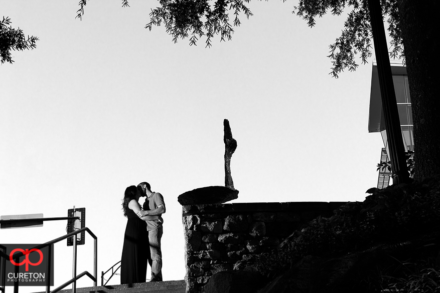 Couple kissing at the top of Falls Park.