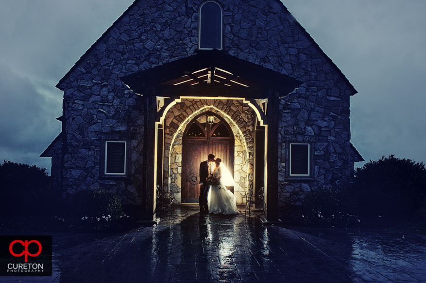 Bride and groom in the rain after their Glassy Chapel wedding.