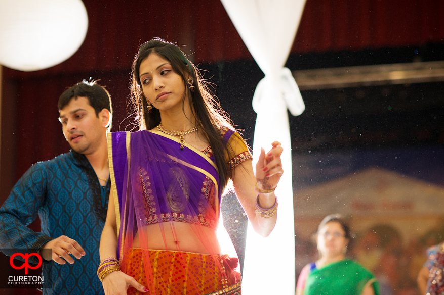 Indian woman in traditional dress dancing.