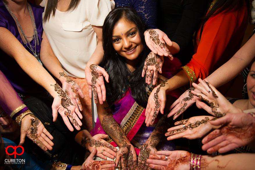 Inidan bride and bridesmaids showing off henna covered palms during her mehndi party in Greenville,SC.