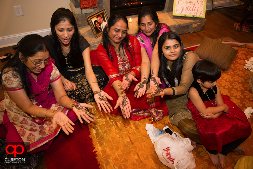 Indian women showing off their henna,.