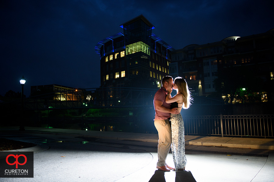 Backlit epic engagement photo with the city lights backdrop.