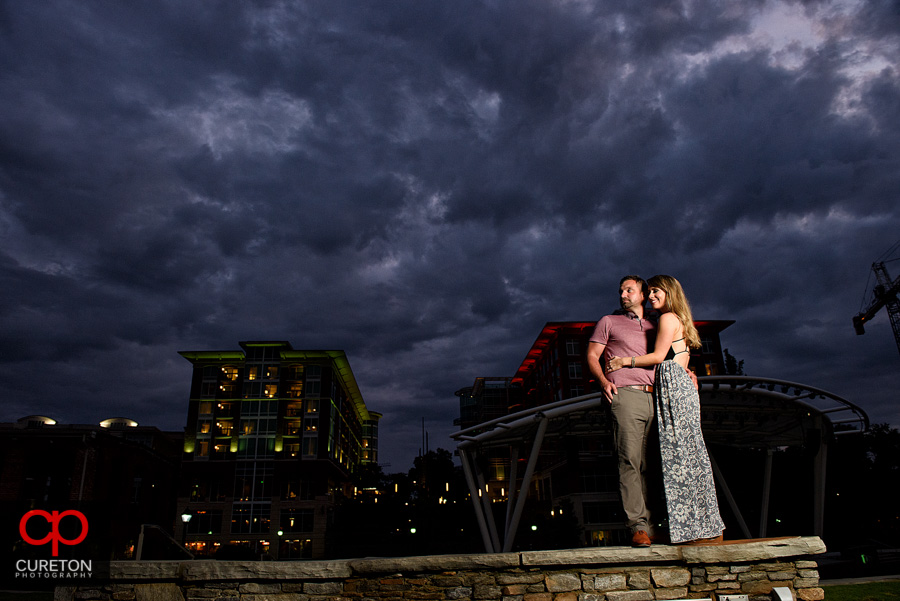 Couple at sunset unser epic downtown Greenville,SC sky.