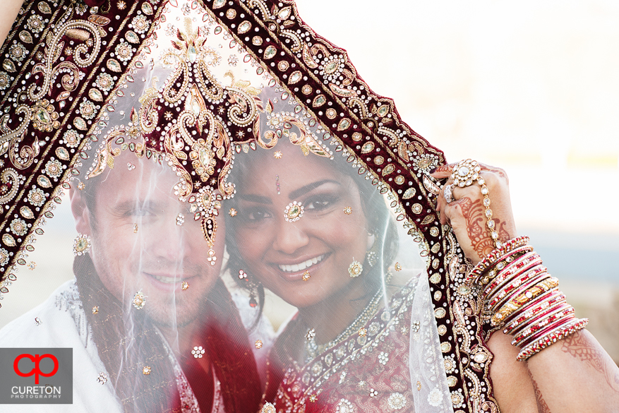 Couple looking through brides veil outside their Indian wedding in Greenville,SC..