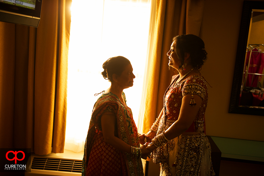 Indian bride and her mother share a moment in gorgeous light before her Indian wedding in Greenville,SC.