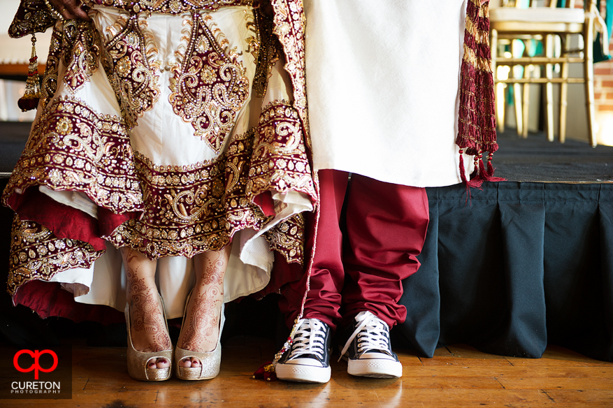 Groom and bride showing their shoes.