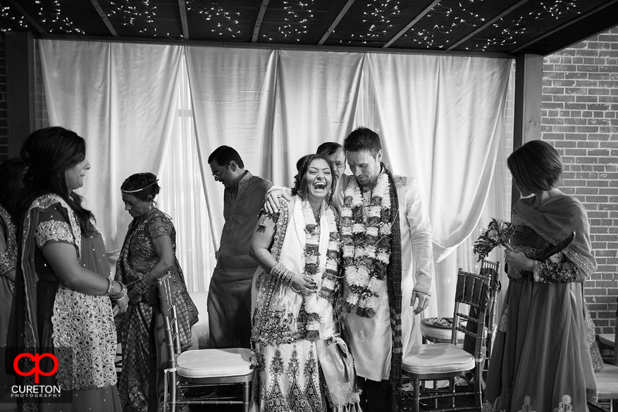 Bride and groom share a laugh during their ceremony.