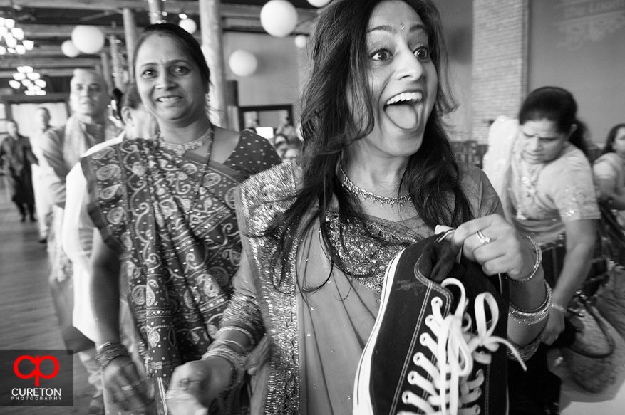 Bridesmaid stealing the grooms shoes.