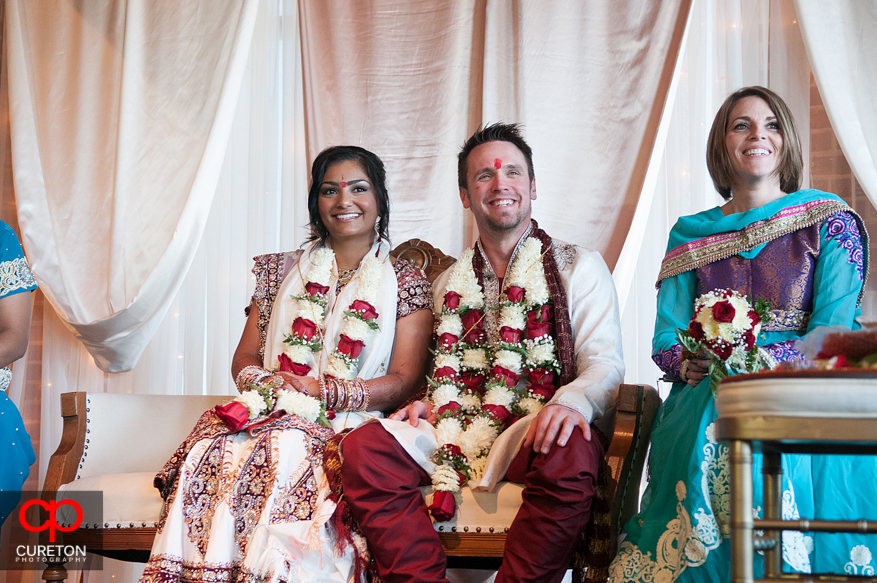 Bride and groom sitting under the mandap.