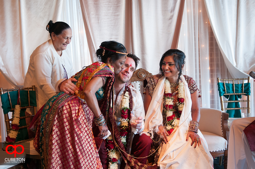 Bride and groom with the bride's mother during the ceremony.