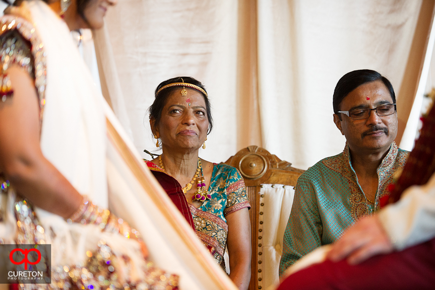 Bride's mother gazes at her daughter during the Indian wedding.