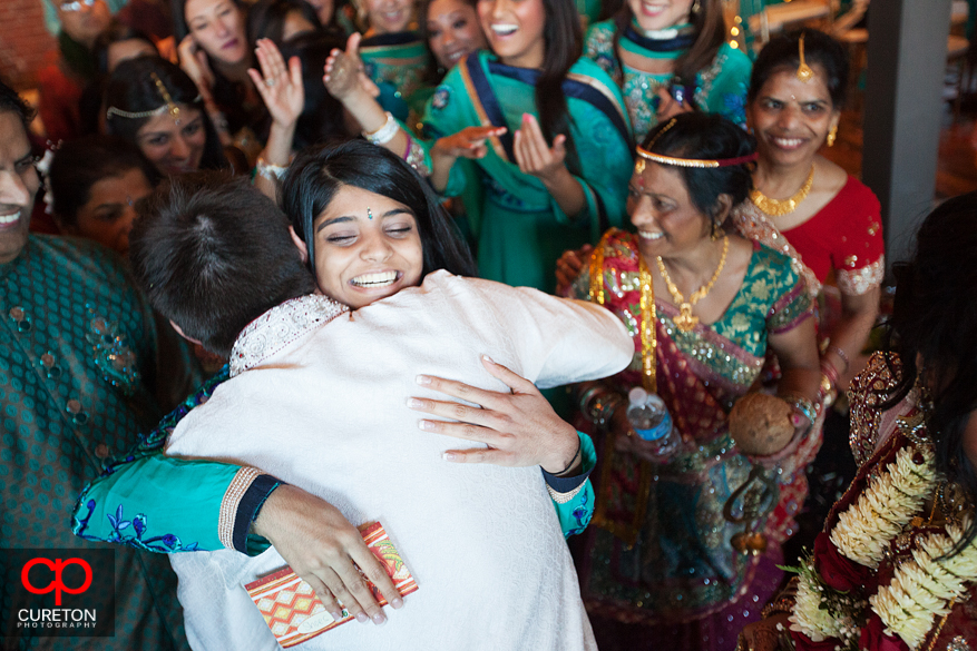 Groom hugs a member of the bride's family after the ceremony.