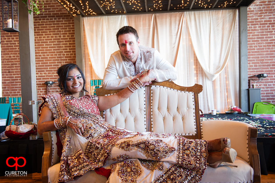 Bride and groom pose under the mandap after their Indian wedding in Greenville,SC..