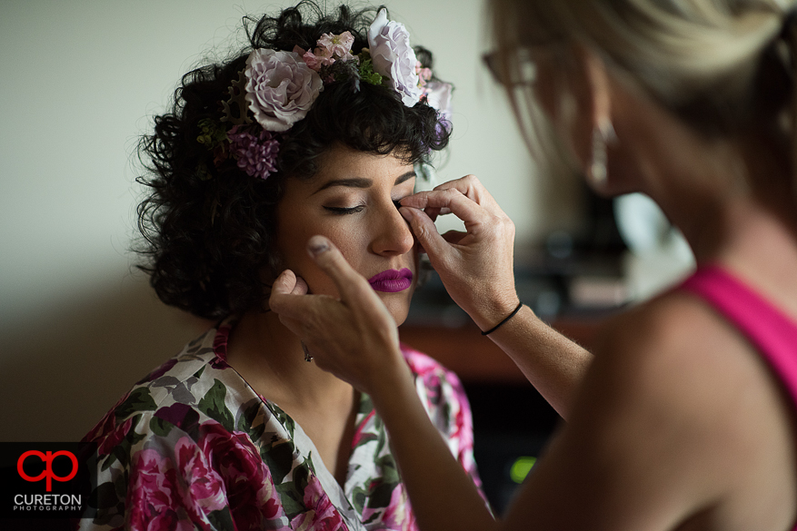 Bride getting lashes put on by Cotton Rouge.