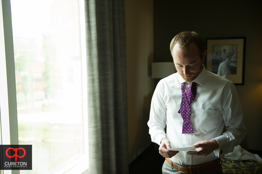 Groom reading a letter from his bride.