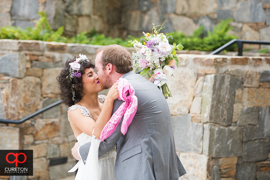 Bride and groom kiss during their first look in downtown Greenville.