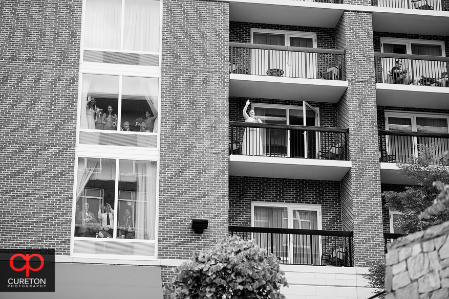 The wedding party watching a first look from the hotel room.