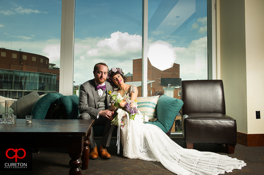 Bride and Groom on the couch at the Lazy Goat.