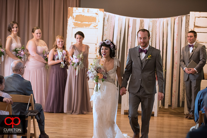 Bride and groom walk back down the aisle.