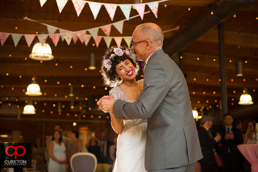 Bride smiles during her dance with her father.