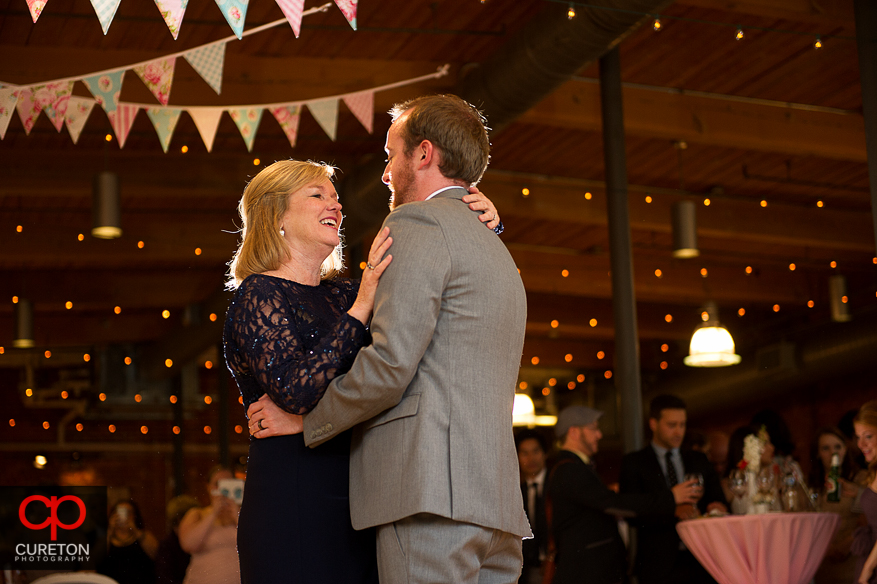 Groom and mother dancing.