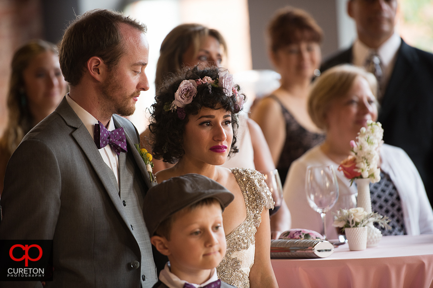 Bride cries at her father's speech.