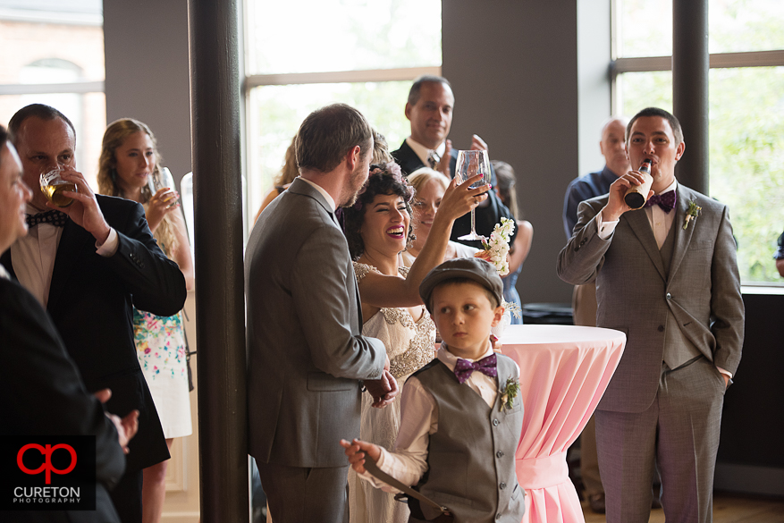 Bride and groom raise a toast.