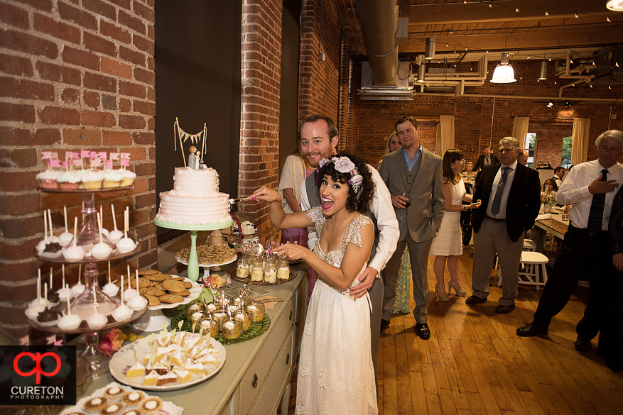 Brie and groom cutting the cake.