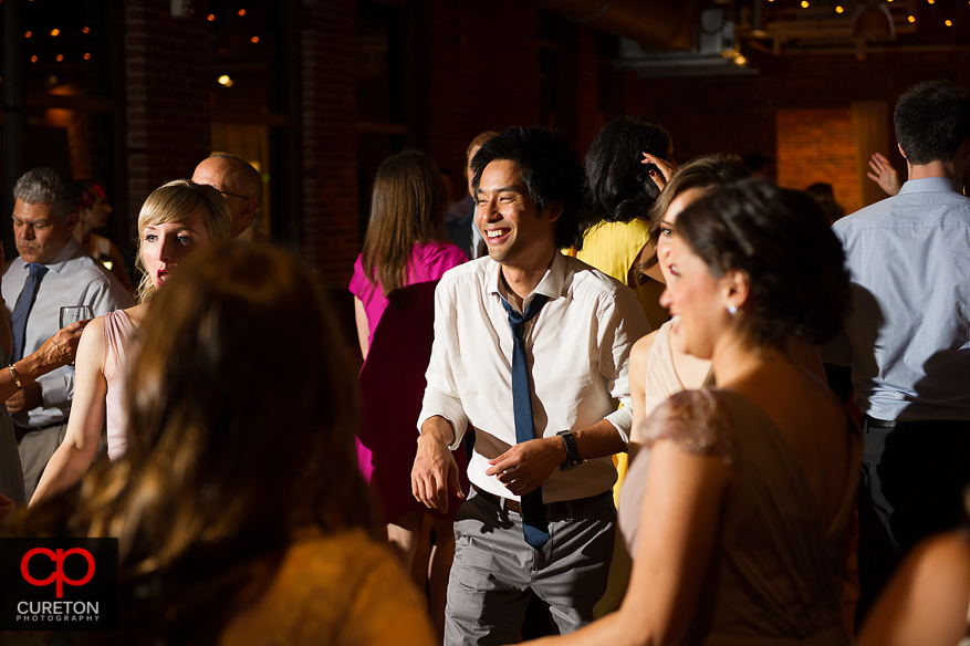 Guests dancing as Uptown Entertainment plays the wedding reception at Certus Loft.