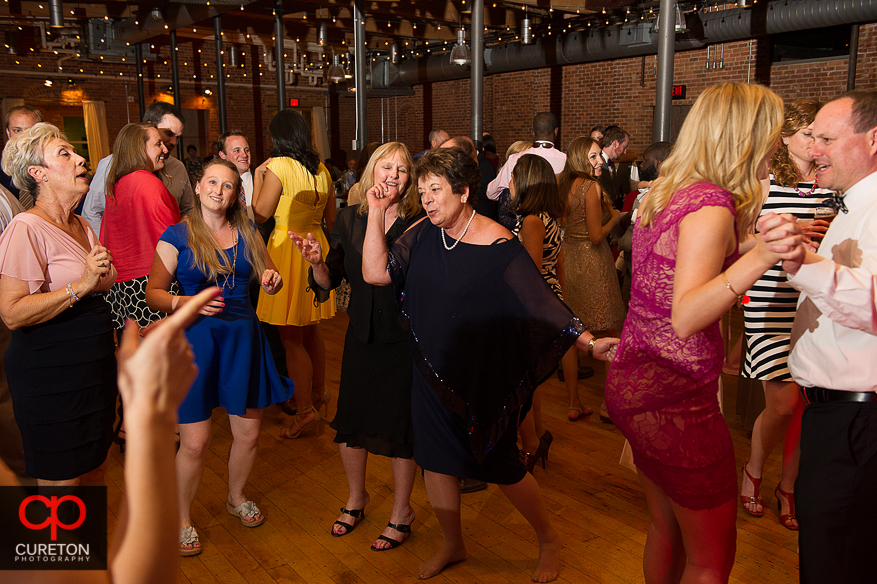 Guests dancing as Uptown Entertainment plays the wedding reception at Certus Loft.
