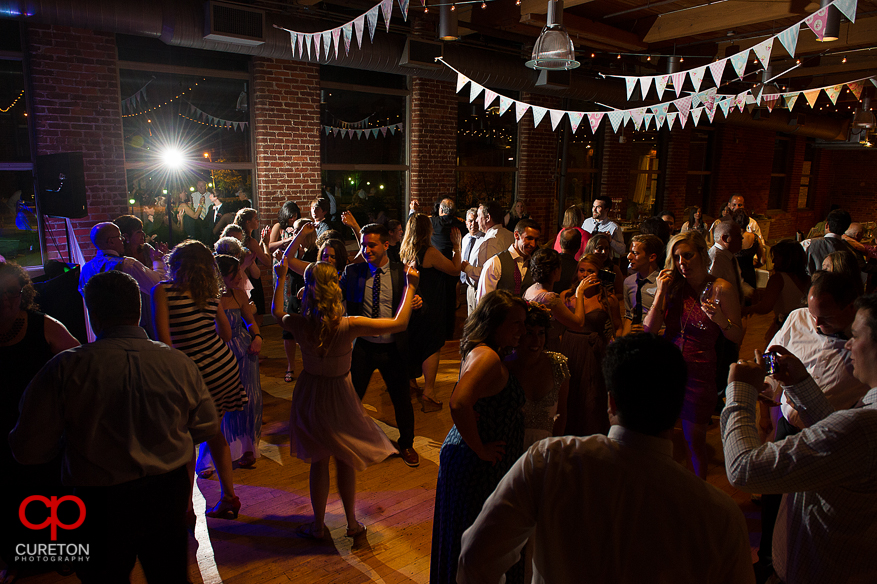 Guests dancing as Uptown Entertainment plays the wedding reception at Certus Loft.