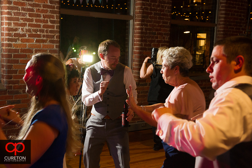 Guests dancing as Uptown Entertainment plays the wedding reception at Certus Loft.