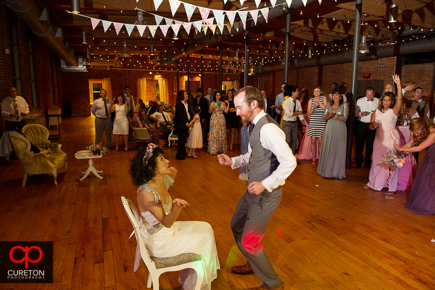 Groom takes off the garter.